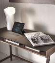 Writing desk with solid walnut-stained ash structure and mocha-colored glass top.