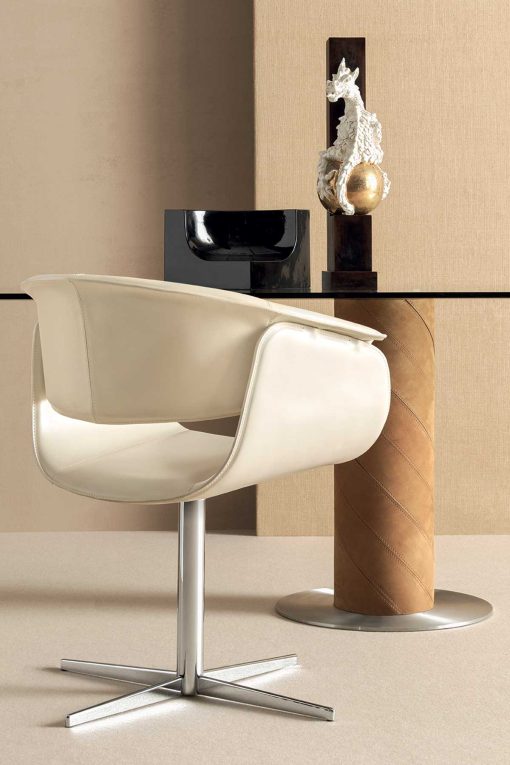 Luxurious swivel leather armchair designed by Noé Duchaufour Lawrance. Ivory colour and shiny chrome cross-shaped base (customizable). Worldwide delivery.