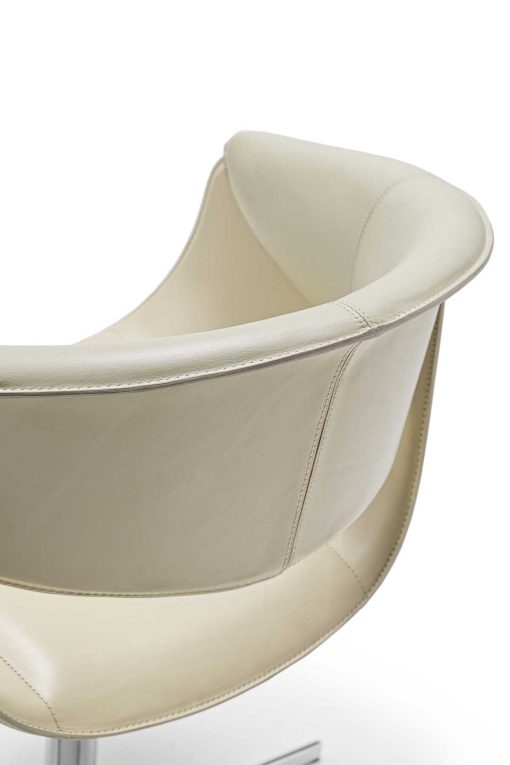 Luxurious swivel leather armchair designed by Noé Duchaufour Lawrance. Ivory colour and shiny chrome cross-shaped base (customizable). Worldwide delivery.