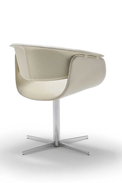 Luxurious swivel leather armchair designed by Noé Duchaufour Lawrance. Ivory colour and shiny chrome cross-shaped base (customizable). Worldwide delivery.