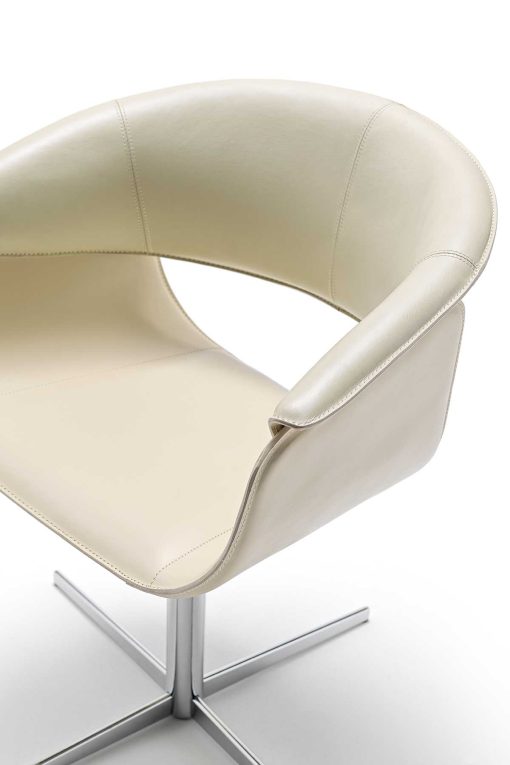 Luxurious swivel leather armchair designed by Noé Duchaufour Lawrance. Ivory colour and shiny chrome cross-shaped base (customizable). Worldwide delivery.