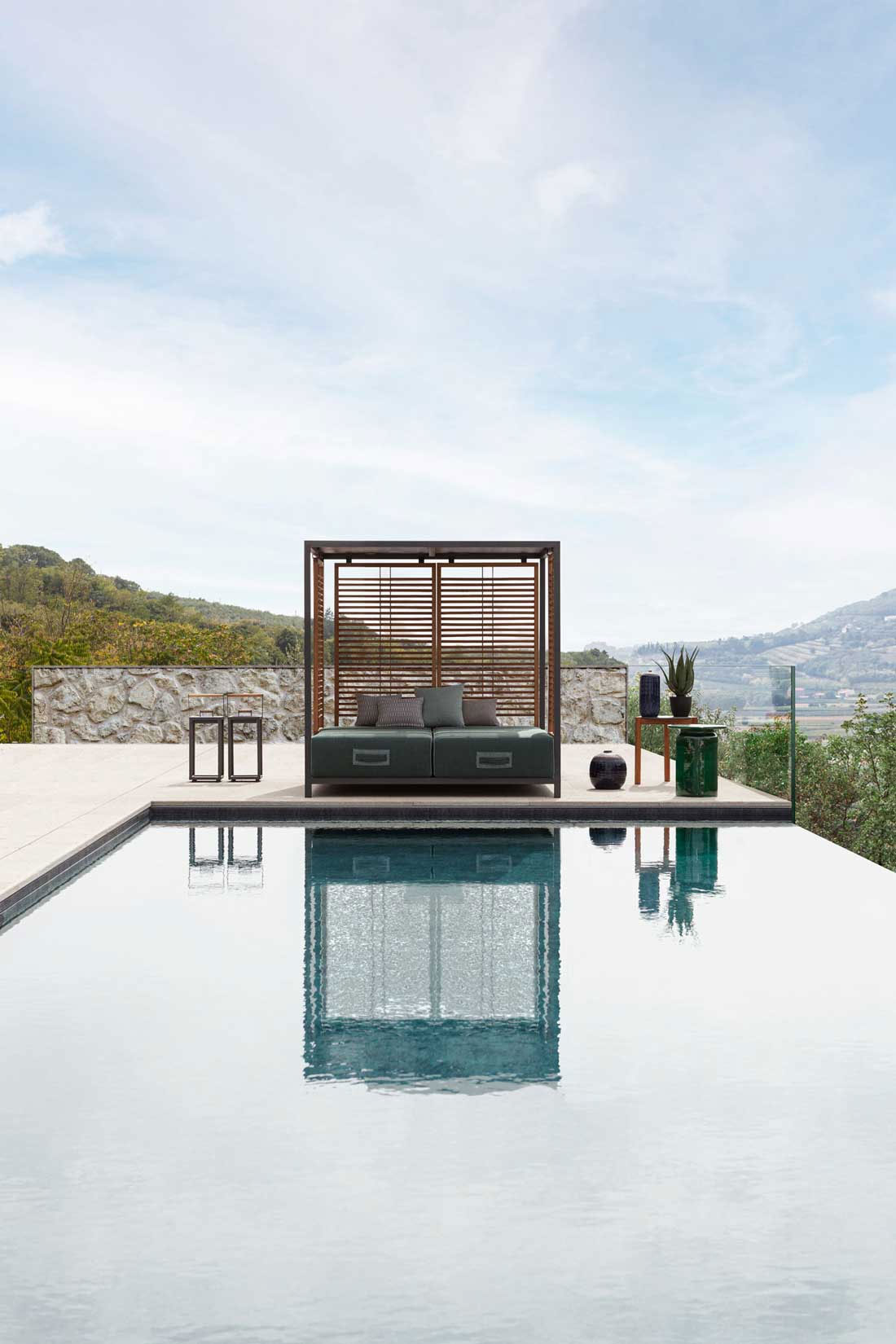 Alcova is an intimate and exclusive outdoor daybed that looks like a large luxurious canopy bed with 2 independent reclining mattresses. Free home delivery.