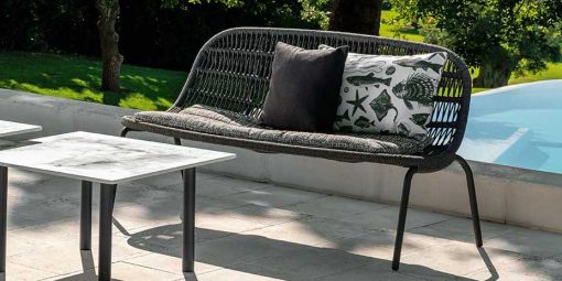 Original grey outdoor love seat designed by L+R Palomba and handcrafted with aluminium and an interweaving of synthetic rope. Online shopping, home delivery