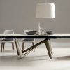 Andrea Lucatello designed a high-end ceramic extensible table, customizable in several finishing. Bicolor base, aluminium frame and barrel-shaped top.