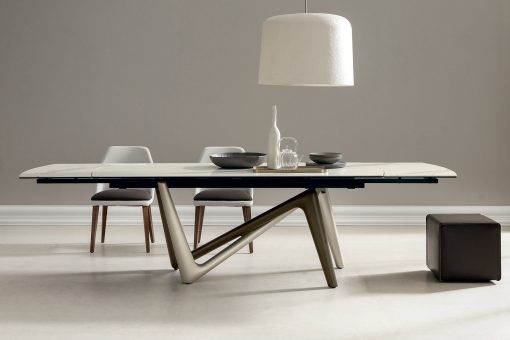 Andrea Lucatello designed a high-end ceramic extensible table, customizable in several finishing. Bicolor base, aluminium frame and barrel-shaped top.