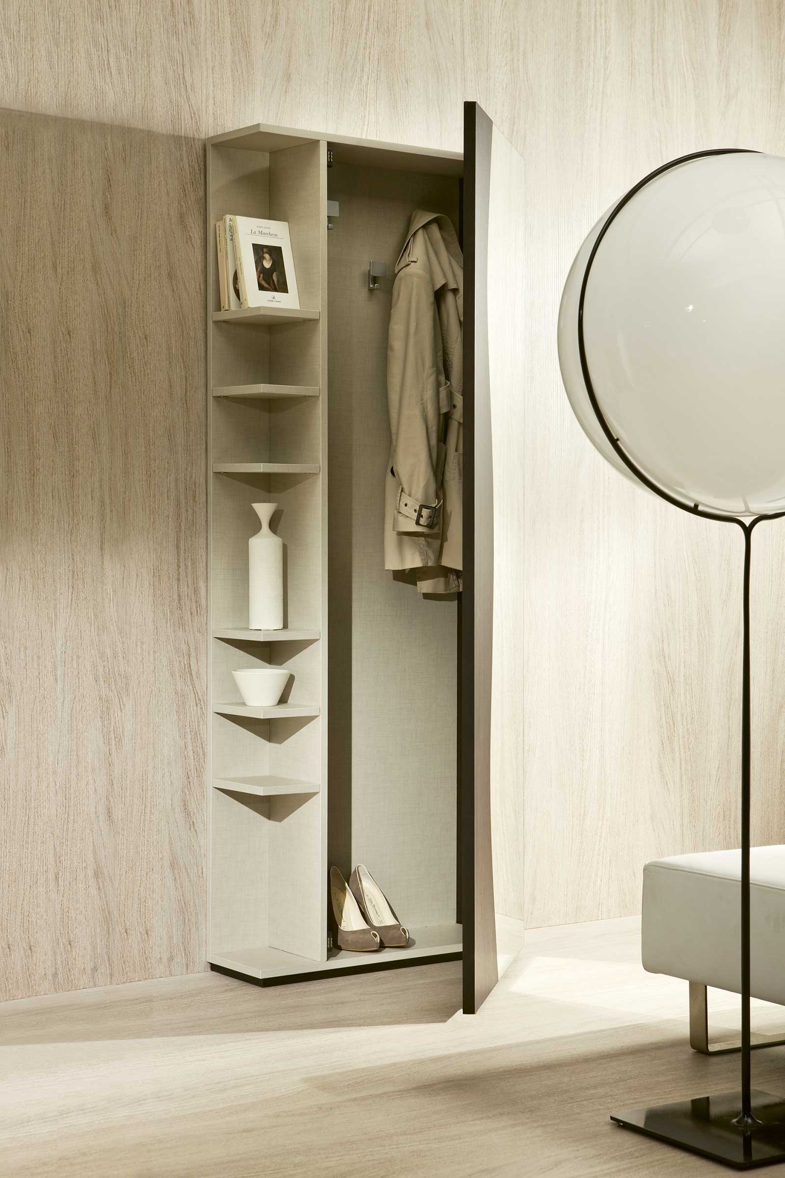FUTUR is an entrance unit in wengé with a coat rack as well as a mirror with side compartments designed by Studio CONTRODESIGN.
