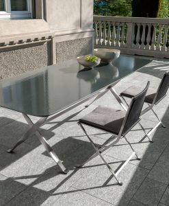 Outdoor rectangular table with a lava stone top and sculptural stainless steel base. Made in Italy. Online shopping and free home delivery.