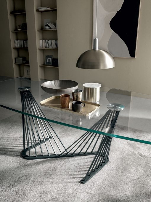 A luxurious table with barrel glass top and metal sinuous base. Andrea Lucatello created it to furnish the most elegant homes. Free home delivery.