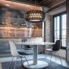 Art of weaving and technical performance. A round scenographic black pendant lamp designed by Elisa Giovannoni. Worldwide home delivery.