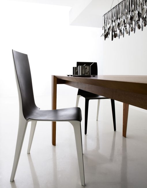 Pulse is an extendable wood dining table designed by Arter & Citton. The graceful curves and designs of this modern dining table are created to add elegance to any room.