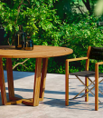 Luxury outdoor round table. Solid Asian teak wood. Luxury furniture for garden and terrace. Online sale.