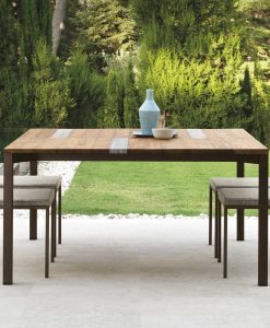 Garden table with stainless steel frame. Top in iroko wood and travertine. Patio furniture design by Ramon Esteve. Shop online for outdoor table and chairs.