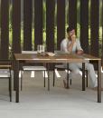 Garden table with stainless steel frame. Top in iroko wood and travertine. Patio furniture design by Ramon Esteve. Shop online for outdoor table and chairs.