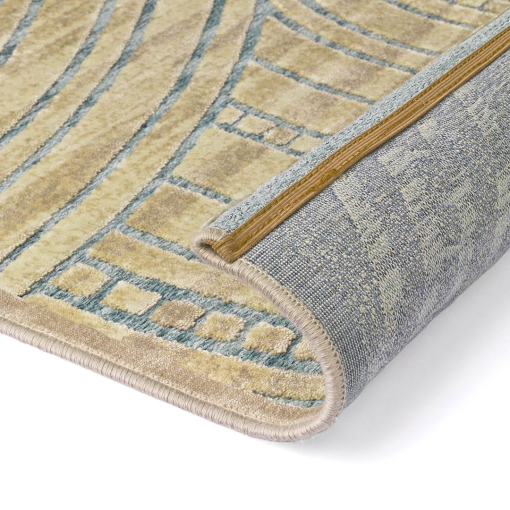 Close-up of Inca-style concentric circle motif in gold and turquoise