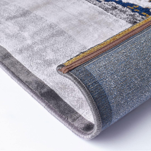 Close-up of embossed golden and blue pattern on rug
