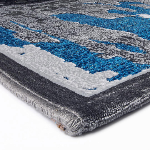 Close-up of embossed golden and blue pattern on rug