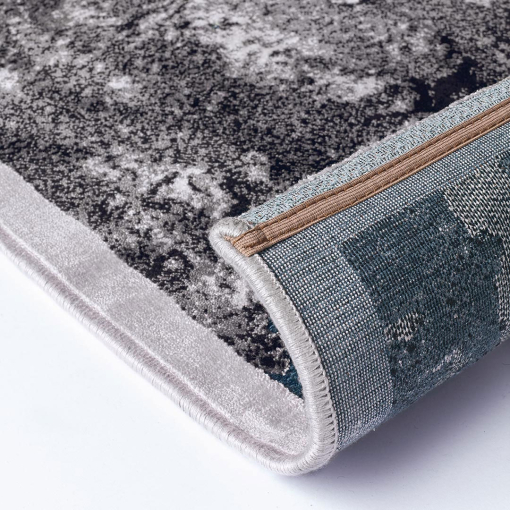 Close-up of turquoise and grey abstract texture on rug