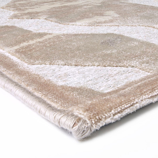 Close-up of interlacing curved lines in light gold on Gabrielle rug
