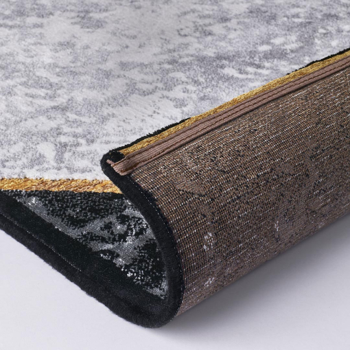 Close-up of intersecting golden lines on marbled grey background