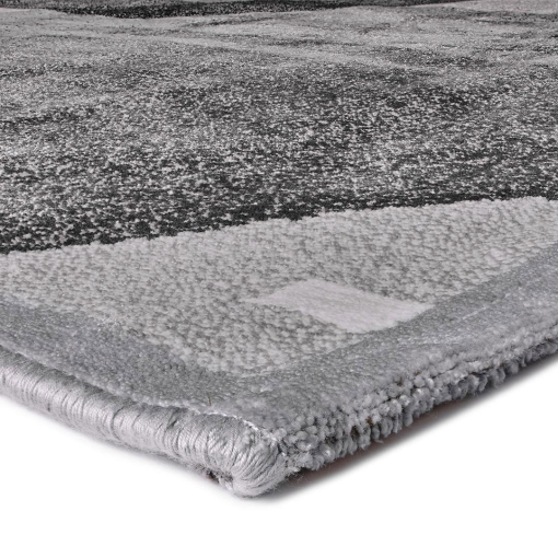 Close-up of stylised golden hexagonal lines on grey rug