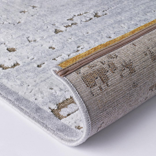 Close-up of overlapping golden and grey circles on rug surface
