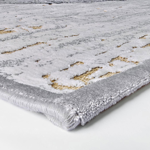 Close-up of overlapping golden and grey circles on rug surface