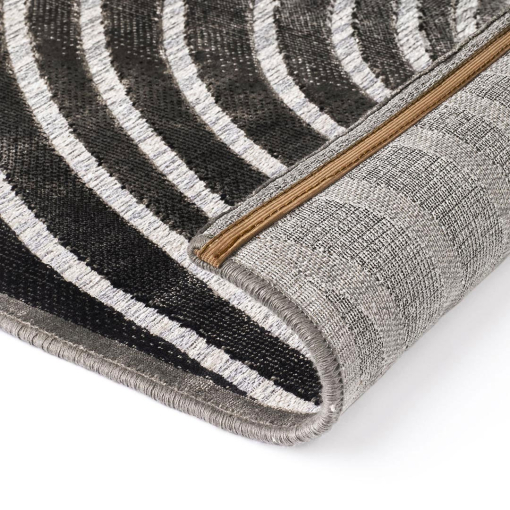 Close-up of concentric curves in light and dark grey on Gabrielle rug