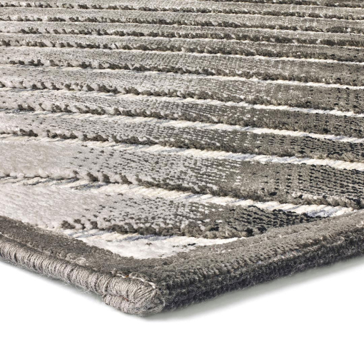 Close-up of concentric curves in light and dark grey on Gabrielle rug